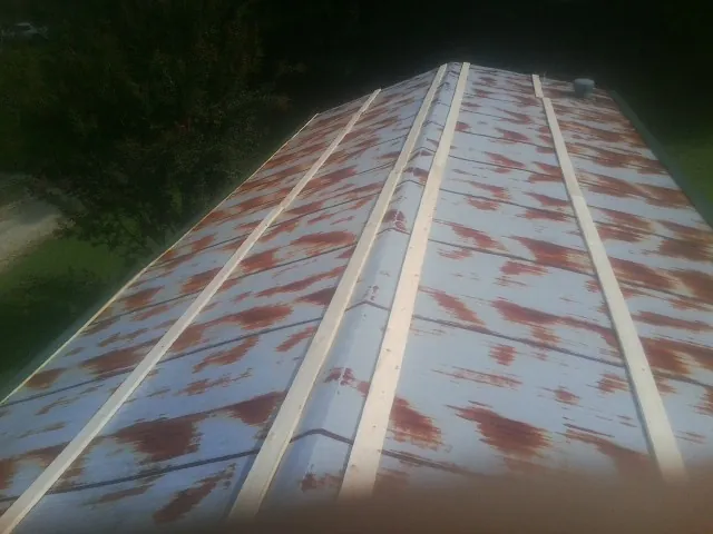 Rusted metal roof panels with new wood purlins before replacement — Storm Damage Roof Repair in Mount Vernon by Roofing Brothers